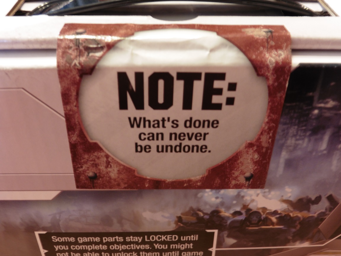 The sticker on the Risk: Legacy box that says 'What's done can never be undone'